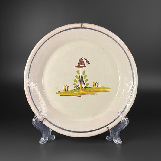 A late 18th-century French faience plate from Nevers, decorated with a hunting hat on a branch in the centre.